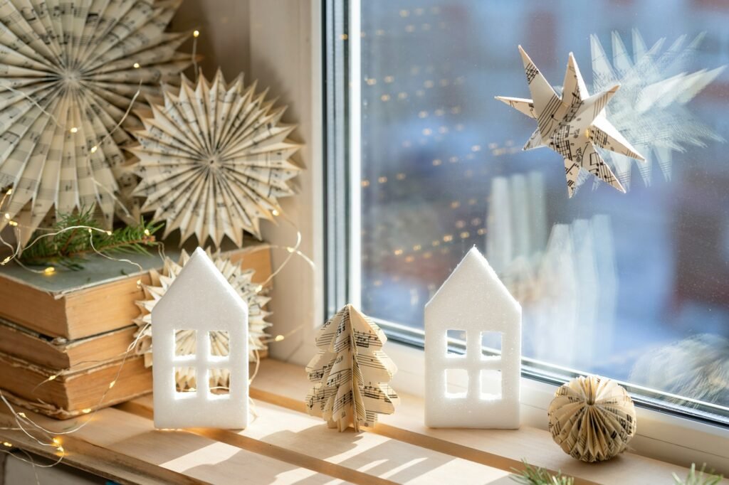 christmas composition by the window books, houses, snowflakes, fir